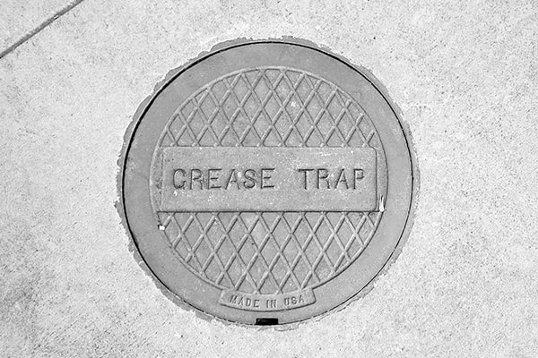 regular grease trap pumping can help prevent sewer line blockages by removing the source of grease and oil buildup